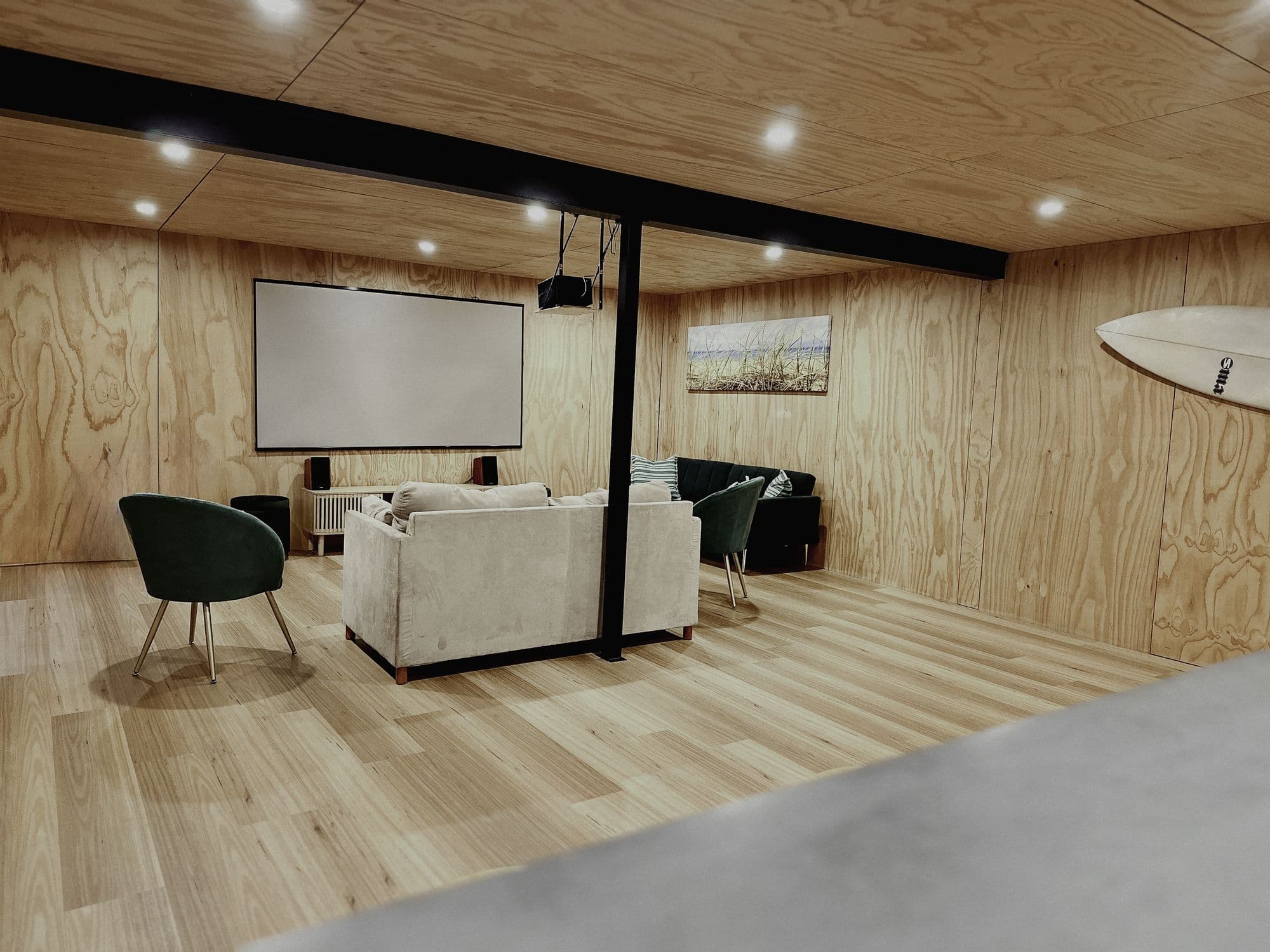 LunaStay — dedicated cinema room with 120-inch projection screen and lounge seating