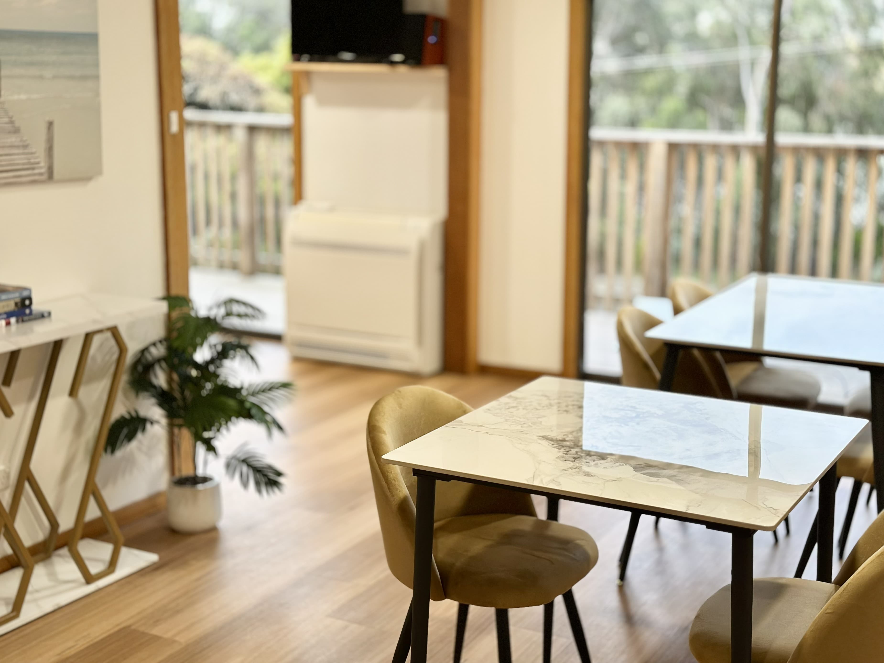 LunaStay — indoor dining opening to the deck and bush